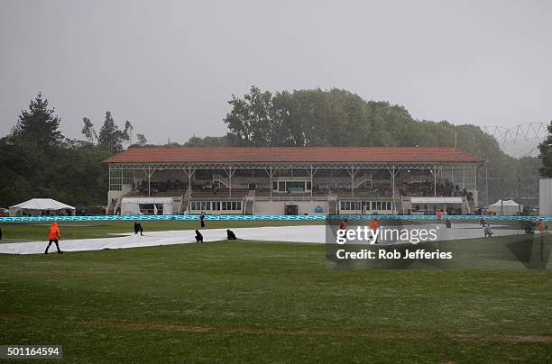 Ground staff lay covers as a wet and wild storm front hits the University Ovel, Dunedin during day four of the First Test match between New Zealand...
