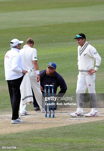 The head groundsmen Tom Tamati undertakes some pitch repairs as requested by Neil Wagner of New Zealand during day four of the First Test match...