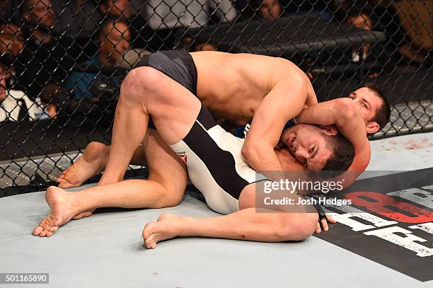 Luke Rockhold attempts to submit Chris Weidman in their UFC middleweight championship bout during the UFC 194 event inside MGM Grand Garden Arena on...