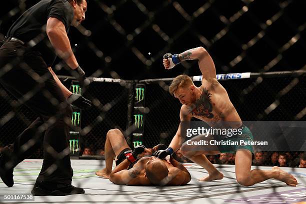 Conor McGregor of Ireland punches Jose Aldo of Brazil in their UFC featherweight championship bout during the UFC 194 event inside MGM Grand Garden...