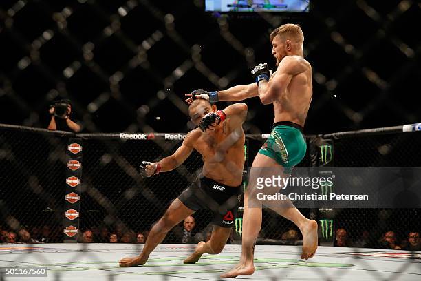 Conor McGregor of Ireland punches Jose Aldo of Brazil in their UFC featherweight championship bout during the UFC 194 event inside MGM Grand Garden...