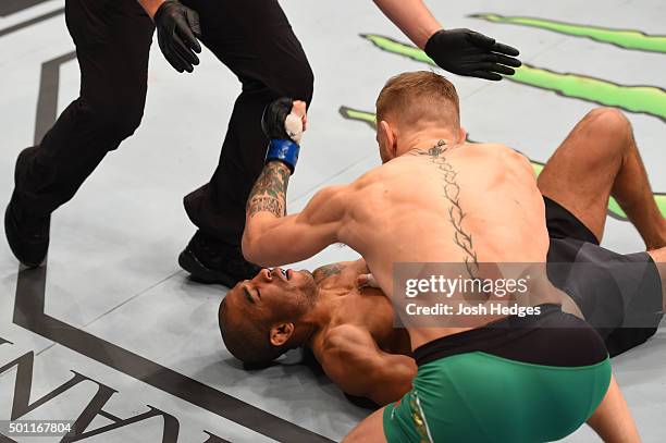 Conor McGregor of Ireland punches Jose Aldo of Brazil in their UFC featherweight championship bout during the UFC 194 event inside MGM Grand Garden...