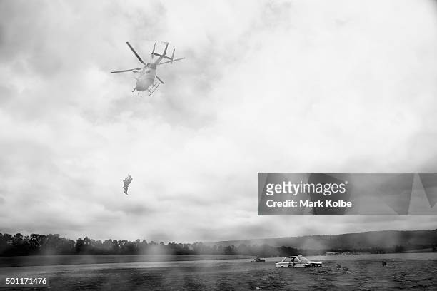 Helicopter winches up an officer and victim during a SES helicopter-based water rescue training exercises at Penrith Whitewater Centre on December...