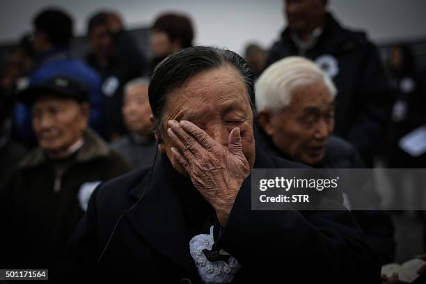 An elderly man cries as people gather in front of the Nanjing Massacre Memorial Hall on the second annual national day of remembrance to commemorate...