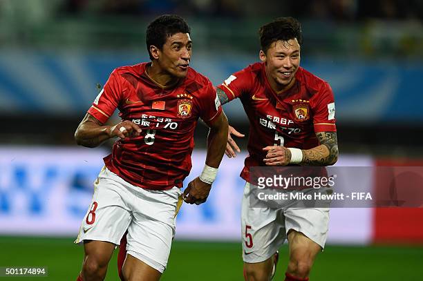 Paulinho of Guangzhou Evergrande FC celebrates with team mate Zhang Linpeng after scoring the winning goal during the FIFA Club World Cup Japan 2015...