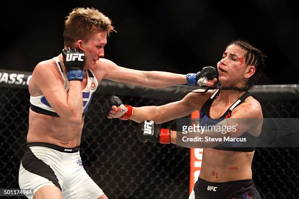 Jocelyn Jones-Lybarger lands a punch on Tecia Torres in a strawweight fight during UFC 194 at MGM Grand Garden Arena on December 12, 2015 in Las...