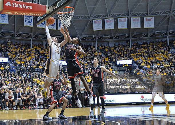 Guard Ron Baker of the Wichita State Shockers drives in for a score against forward Derrick Jones Jr. #1 of the UNLV Rebels during the first half on...