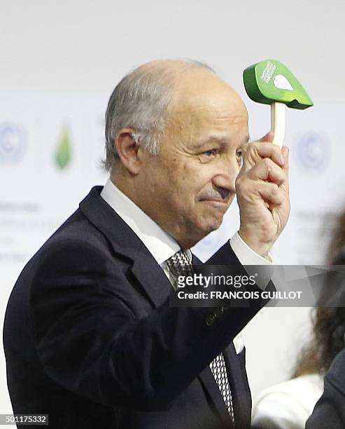 Foreign Affairs Minister and President-designate of COP21 Laurent Fabius waves the official gavel of the COP 21 Climate Conference, as France's...