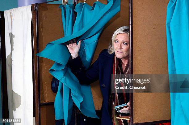 French far-right Front National party's President Marine Le Pen candidate for the regional election in the Nord-Pas-de-Calais-Picardie region leaves...