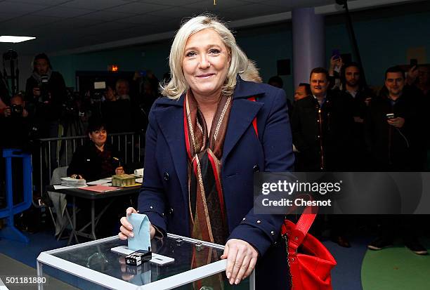 French far-right Front National party's President Marine Le Pen, candidate for the regional election in the Nord-Pas-de-Calais-Picardie region, casts...