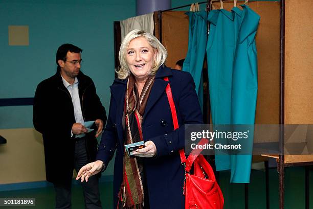 French far-right Front National party's President Marine Le Pen candidate for the regional election in the Nord-Pas-de-Calais-Picardie region leaves...