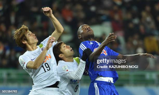Congolese side Mazembe forward Mbwana Samatta , Japan's Sanfrecce Hiroshima midfielder Kazuyuki Morisaki and defender Sho Sasaki look at the ball...