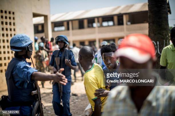 Burundian soldiers from the MINUSCA, the United Nations mission in Central African Republic, direct civilians to cover as heavy gunfire is directed...