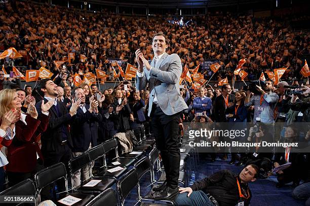 Albert Rivera , leader of Ciudadanos stands on a chair to aplause to his supporters as a man sit on the ground to hold the chair during a campaign...