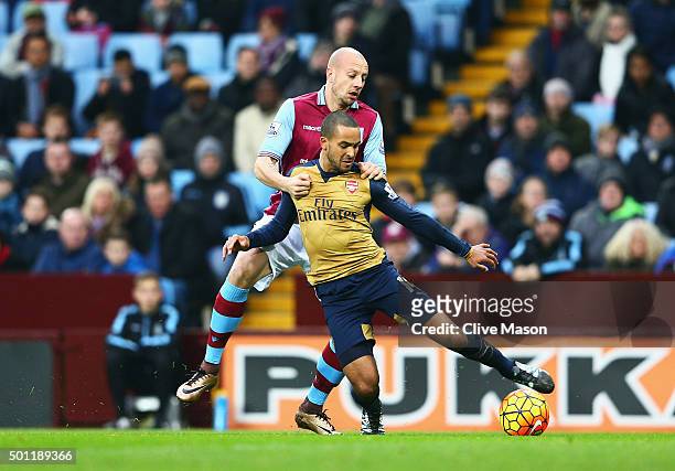 Alan Hutton of Aston Villa pulls back to Theo Walcott of Arsenal to concede a penalty during the Barclays Premier League match between Aston Villa...