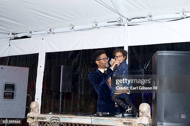 Singer/Songwriter Eric Benet and his daughter Lucia Bella share the microphone at the In A Perfect World 10 Year Celebration Of Giving on December...