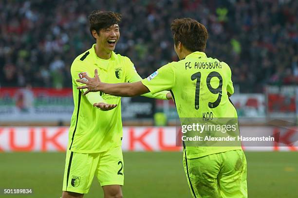 Jeong-Ho Hong of Augsburg celebrates scoring the opening goal with his team mate Ja-Cheol Koo during the Bundesliga match between FC Augsburg and FC...