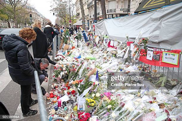 People gather in front of 'Le Bataclan' concert hall where 89 people where killed during the paris attacks a month ago on December 13, 2015 in Paris,...