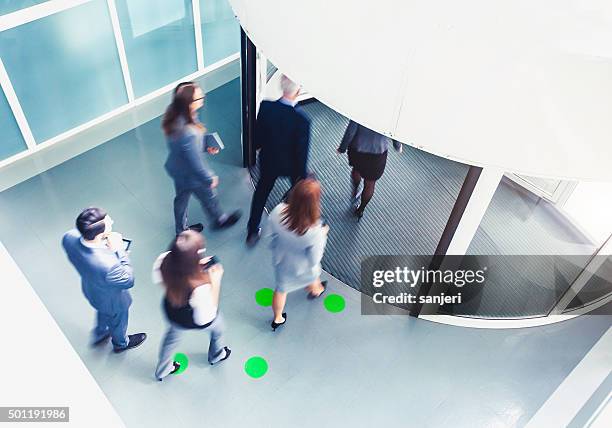 rush hour with business people - revolving door stock pictures, royalty-free photos & images