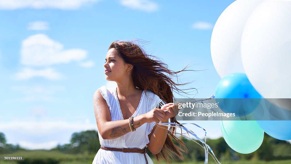 Enjoying the day with her baloons