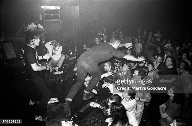 Stagediver jumps into the crowd as Napalm Death perform on stage at the ICA, London, United Kingdom, 1990.