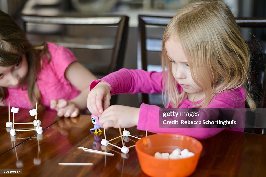 Young girls concentrating on making crafts