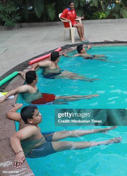 People participate in aqua aerobics classes during a "No TV Day" weekend fest organized by Hindustan Times, at Wadala on December 12, 2015 in Mumbai,...