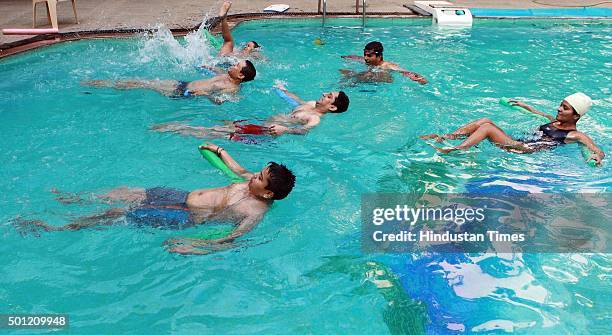 People participate in aqua aerobics classes during a "No TV Day" weekend fest organized by Hindustan Times, at Wadala on December 12, 2015 in Mumbai,...