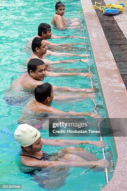 People participate in aqua aerobics classes during a "No TV Day" weekend fest organized by Hindustan Times, at Wadala on December 12, 2015 in Mumbai,...