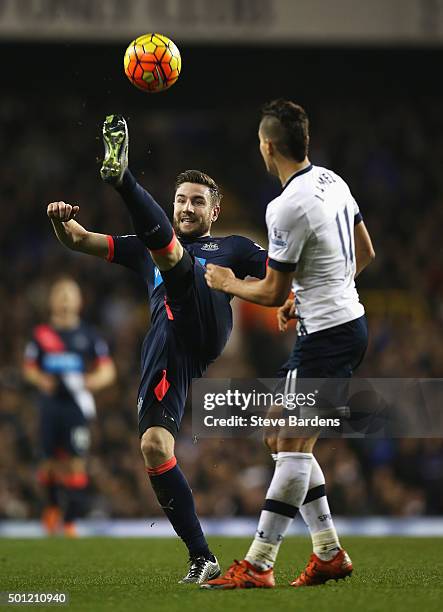 Paul Dummett of Newcastle United clears the ball from Erik Lamela of Tottenham Hotspur during the Barclays Premier League match between Tottenham...