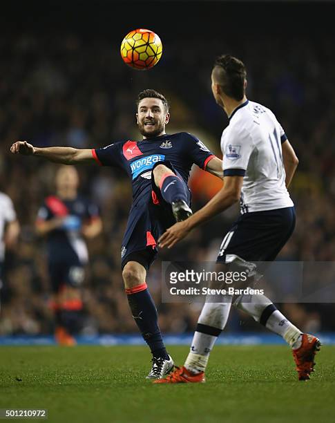 Paul Dummett of Newcastle United clears the ball from Erik Lamela of Tottenham Hotspur during the Barclays Premier League match between Tottenham...