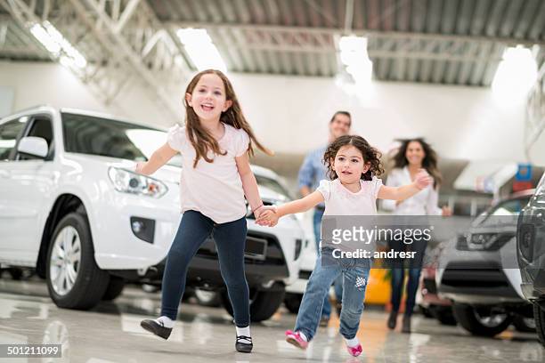 family at a car dealership - autoshow stockfoto's en -beelden