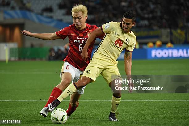 Andres Andrade of the Club America and Feng Xiaoting of Guangzhou Evergrande FC compete for the ball during the FIFA Club World Cup quarter final...