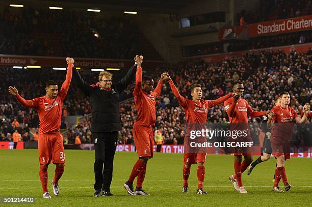 Liverpool's German manager Jurgen Klopp leads his players in saluting the crowd with Liverpool's English midfielder Jordon Ibe, Liverpool's Belgian...