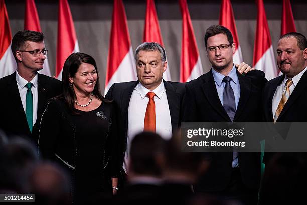 Viktor Orban, Hungary's prime minister, center, stands with politicians from the Fidesz party, Gabor Kubatov, left, Ildiko Pelczne Gal, second left,...