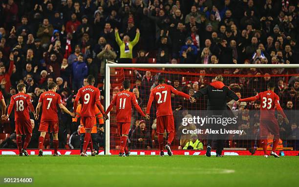 Jurgen Klopp, manager of Liverpool and player salute The Kop after the Barclays Premier League match between Liverpool and West Bromwich Albion at...