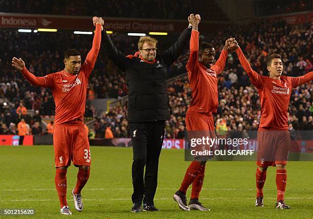 Liverpool's German manager Jurgen Klopp leads his players in saluting the crowd with Liverpool's English midfielder Jordon Ibe, Liverpool's Belgian...