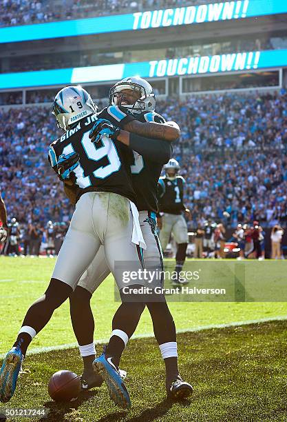 Ted Ginn celebrates with teammate Corey Brown of the Carolina Panthers after scoring a touchdown against the Atlanta Falcons during their game at...