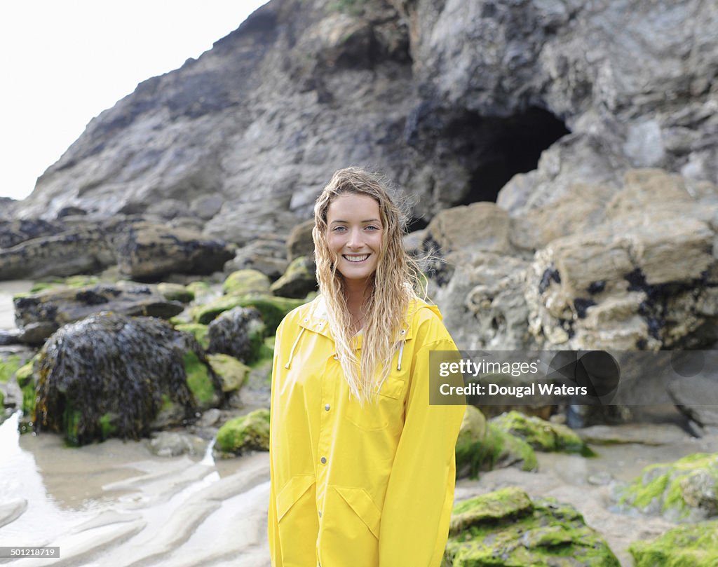 Portrait of woman smiling on rocky coast