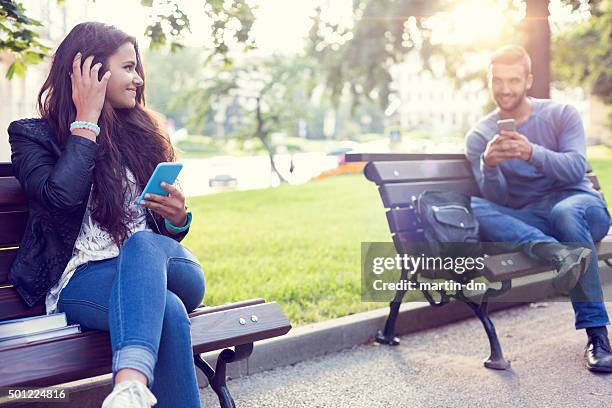 flirting couple in the park - love at first sight stock pictures, royalty-free photos & images