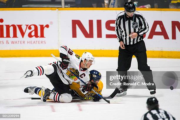 Jonathan Toews of the Chicago Blackhawks tangles with Filip Forsberg of the Nashville Predators during a NHL at Bridgestone Arena on December 10,...