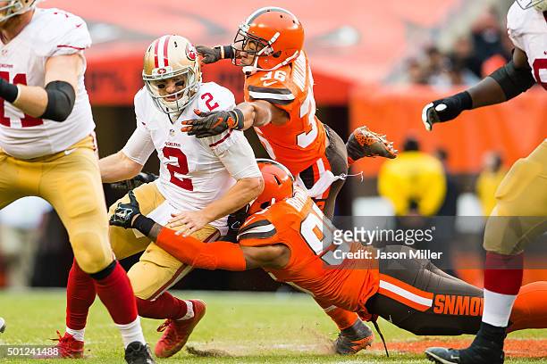 Quarterback Blaine Gabbert of the San Francisco 49ers is sacked by outside linebacker Armonty Bryant and free safety K'Waun Williams of the Cleveland...