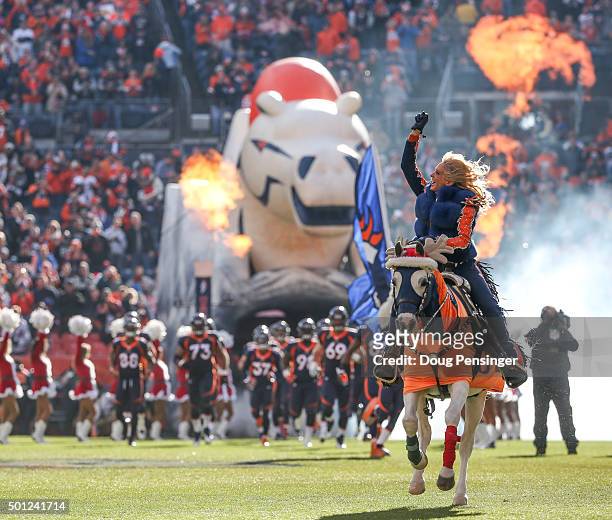 Equestrian Ann Judge-Wegener rides Denver Broncos mascot "Thunder" out of the tunnel during player introductions during the pre game ceremony before...