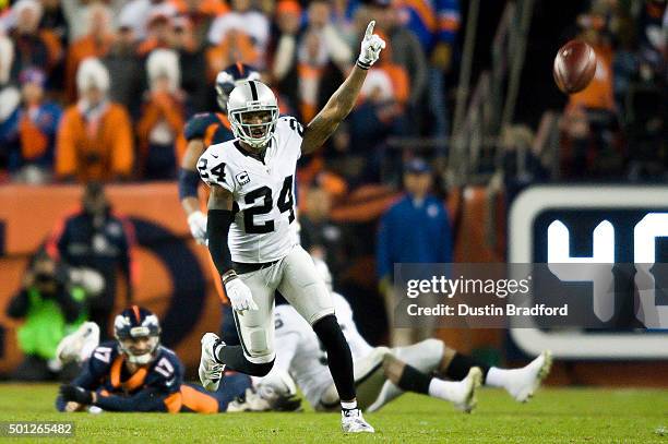 Free safety Charles Woodson of the Oakland Raiders celebrates a game-sealing play as quarterback Brock Osweiler of the Denver Broncos lied on the...