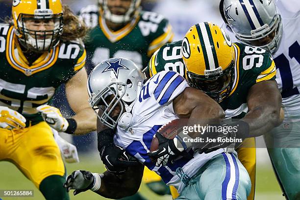 Letroy Guion of the Green Bay Packers tackles Robert Turbin of the Dallas Cowboys in the first half at Lambeau Field on December 13, 2015 in Green...