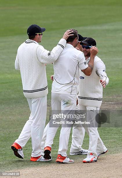 Doug Bracewell of New Zealand is congratulated on taking the wicket of Suranga Lakmal of Sri Lanka during day five of the First Test match between...