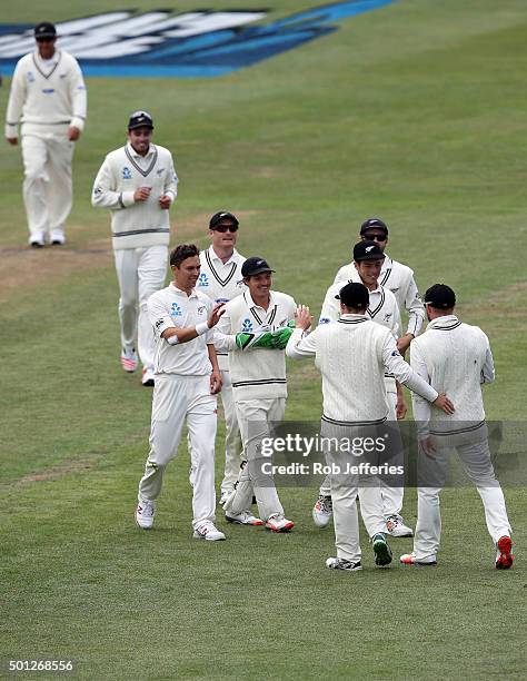 The New Zealand team rush to congratulate Brendon McCullum on a stunning catch off the bowling of Trent Boult to dismiss Milinda Siriwardana of Sri...