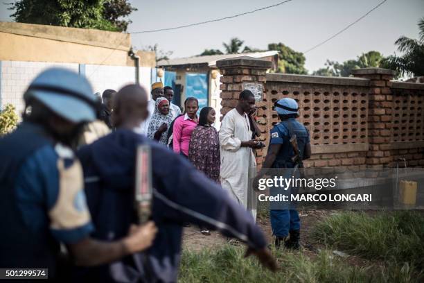 Burundian soldier of the UN peacekeeping force MINUSCA contingent uses a metal detector at the entrance of a polling station in the flashpoint PK5...