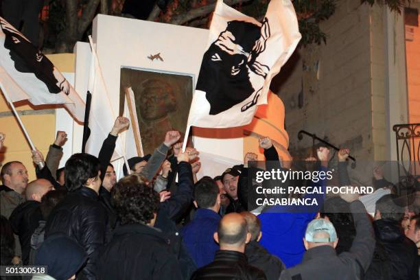 People wave the flag of Corsica as they celebrate after the announcement of the second round results of the regional election on December 13, 2015 in...