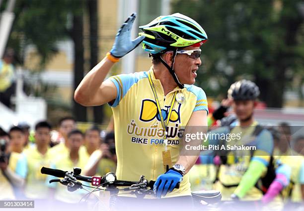 Thailand's Crown Prince Maha Vajiralongkorn waves to the crowd as he cycles in the "Bike for Dad" event in Bangkok. Thai Crown Prince Maha...